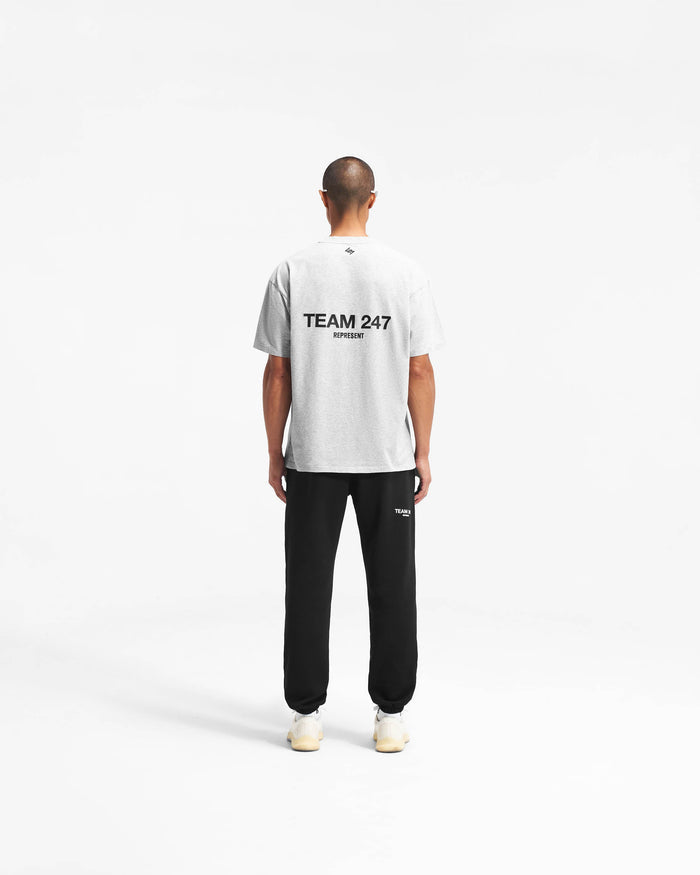 Man wearing a grey oversized t-shirt on a plain white background | Team 247 Oversized T-Shirt in Ash Grey | Quick dry lightweight gym top with 4-way stretch | 247 T-Shirts | Represent Clo