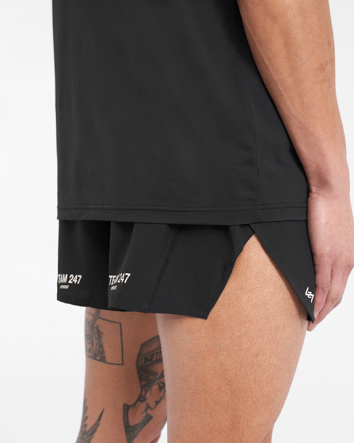 Man wearing black race shorts on a plain white background | Team 247 Race Shorts in Jet Black | Polyester shorts with large side split and zip pocket | 247 Shorts | Represent Clo