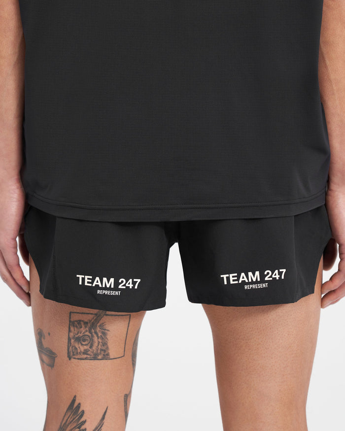 Man wearing black race shorts on a plain white background | Team 247 Race Shorts in Jet Black | Polyester shorts with side split and zip pocket | 247 Shorts | Represent Clo
