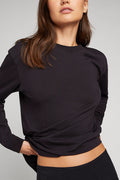 Black crew-neck long-sleeve uniform top with twisted front hem