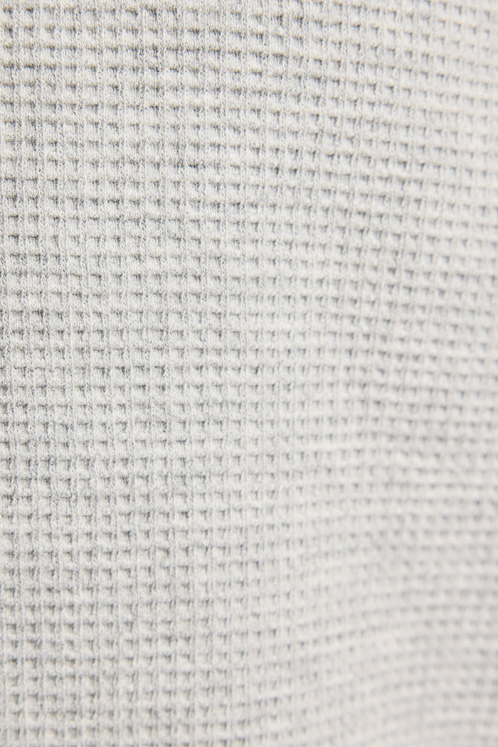 Light heather grey waffle knit fabric close-up texture