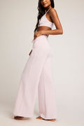 Waffle knit track pants in light pink with relaxed full-length wide legs.