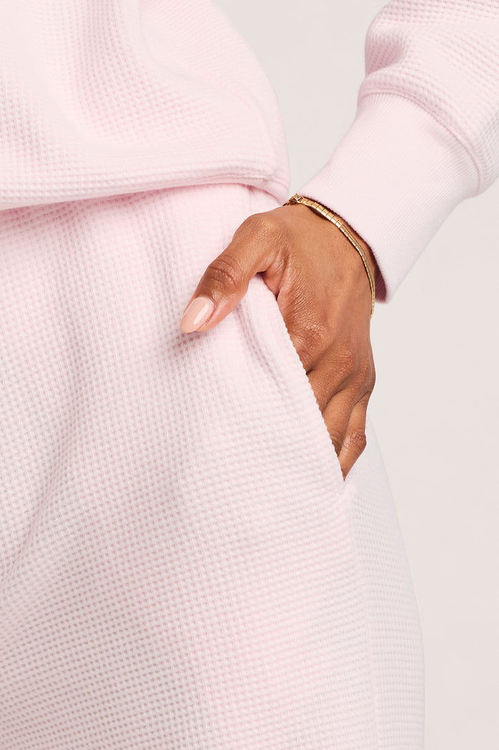 Waffle knit track pants in light pink, elastic waistband and side pocket detail.