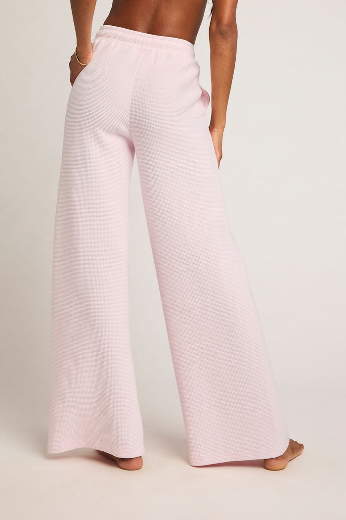 Waffle knit track pants in light pink, relaxed wide-leg silhouette with ankle length.