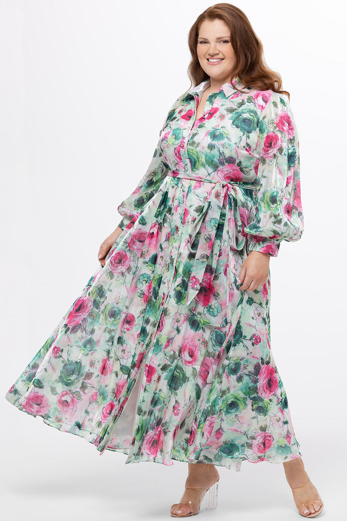 Celebration's by Sydney's Closet style CE2621 in floral. 

Button down plus size ankle length floral gown made from printed organza. V-neck, long pouf sleeves with cuff and optional belt. A-line skirt with pockets.