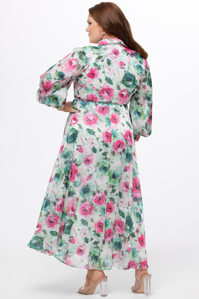 Celebration's by Sydney's Closet style CE2621 in floral. 

Button down plus size ankle length floral gown made from printed organza. V-neck, long pouf sleeves with cuff and optional belt. A-line skirt with pockets.