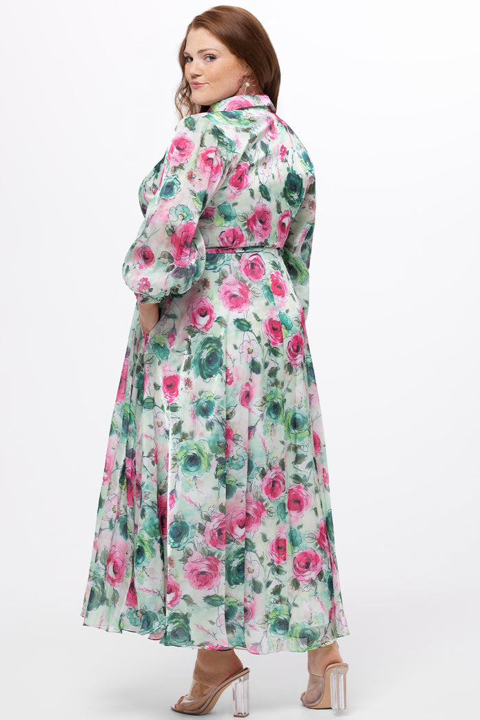Celebration's by Sydney's Closet style CE2621 in floral. 

Button down plus size ankle length floral gown made from printed organza. V-neck, long pouf sleeves with cuff and optional belt. A-line skirt with pockets.