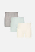 Three pairs of women's boxer briefs in heather gray, pale mint green, and cream, arranged in a staggered overlapping layout on a light gray background.