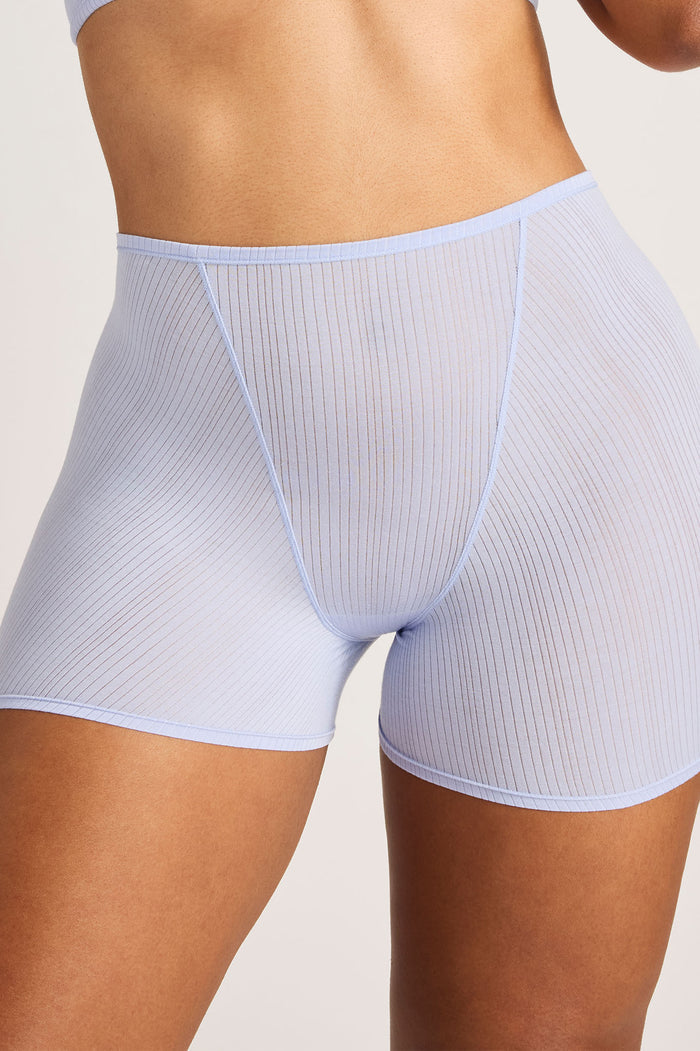 Light blue ribbed underwear on a neutral background