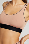 Buff non-wire bra top close-up with black trim along neckline and straps