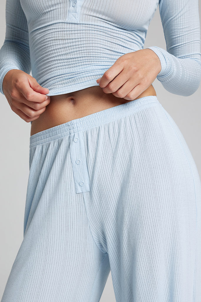 Light blue track pants waistband with front button placket and gathered elastic