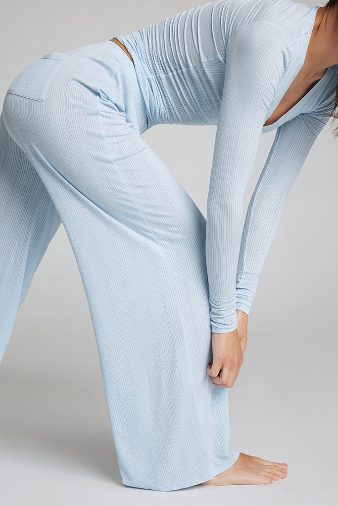 Light blue ribbed knit track pants with side seam detail and wide flared leg