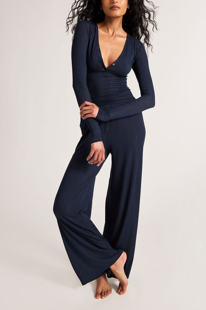 Navy track pants with gathered waist and wide straight legs, full-length