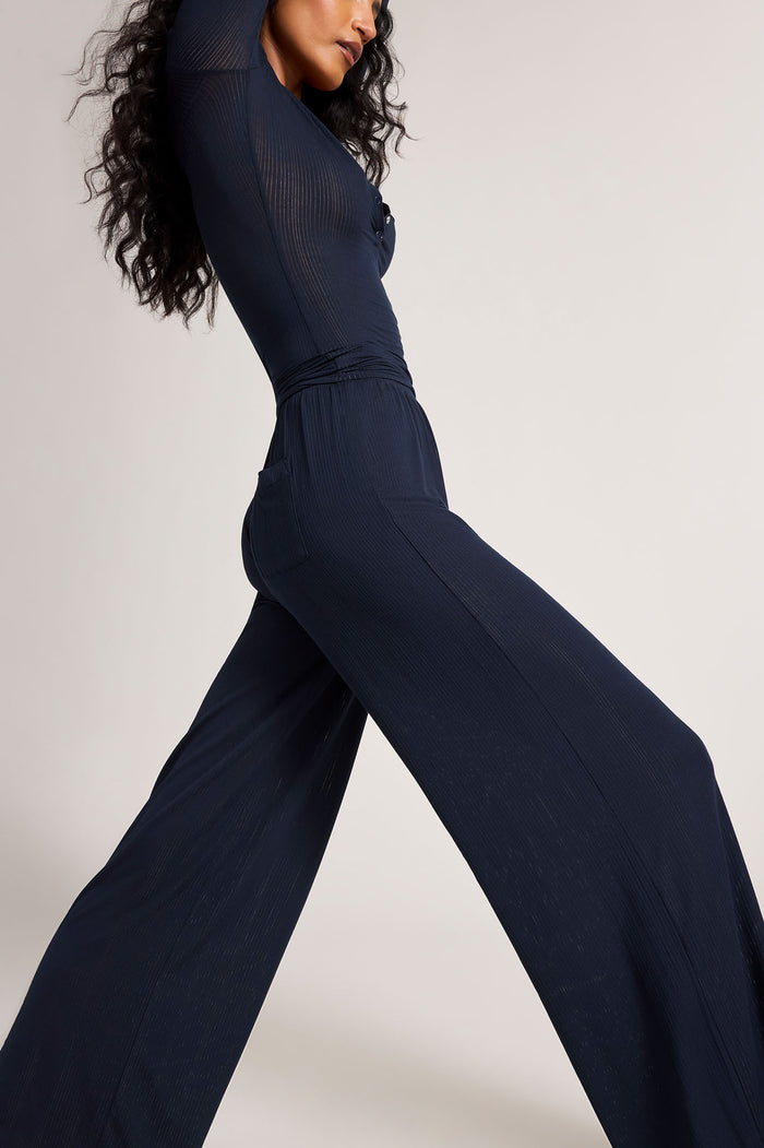 Navy wide-leg track pants, angled side view, ruched detail at waist