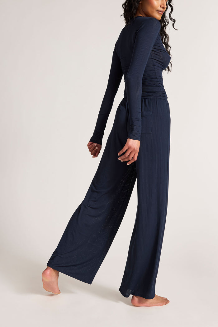 Navy wide-leg track pants, side view, long length with elastic waist